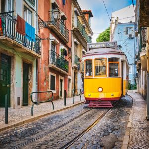 Famous,Vintage,Yellow,Tram,28,In,The,Narrow,Streets,Of