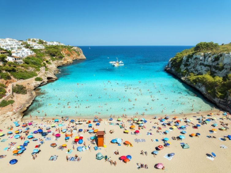 Aerial,View,Of,Colorful,Umbrellas,On,Crowded,Sandy,Beach,,Boats,